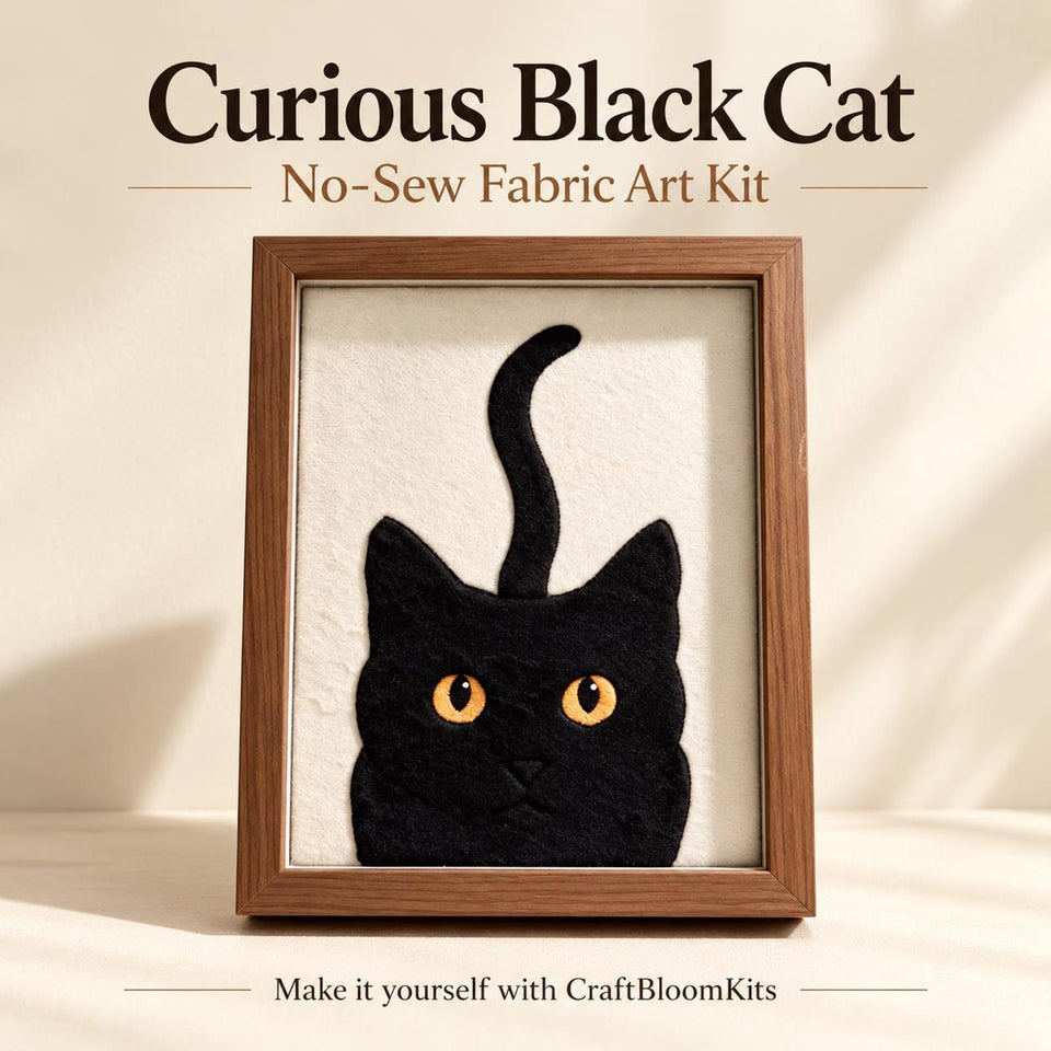 May include: A framed fabric art piece titled Curious Black Cat No-Sew Fabric Art Kit. The artwork features a black cat silhouette with bright orange eyes on a cream background, encased in a brown wooden frame. Text includes Curious Black Cat, No-Sew Fabric Art Kit, and Make it yourself with CraftBloomKits.