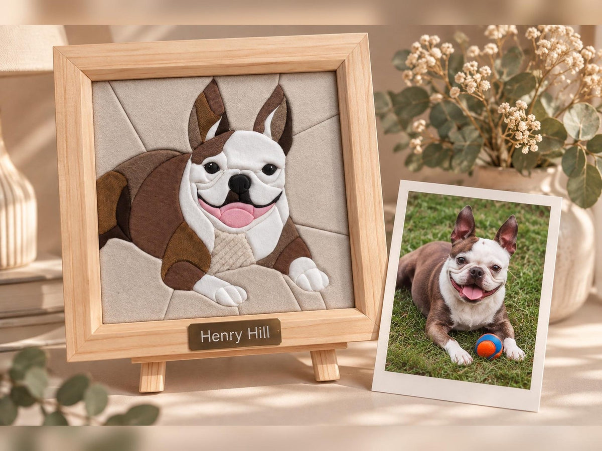 May include: A square light wood frame containing a fabric mosaic of a brown and white French Bulldog with a pink tongue. A small metal plaque at the bottom reads Henry Hill. Next to it is a rectangular photograph of the same dog on grass.