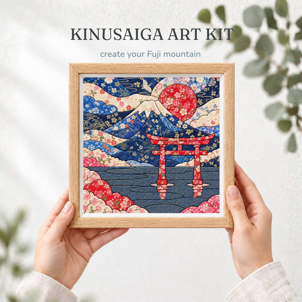 May include: A square Kinusaiga art kit featuring a framed fabric collage of Mount Fuji, a red torii gate, and a large red sun. The artwork displays intricate floral patterns in shades of blue, red, and cream, with the text KINUSAIGA ART KIT.